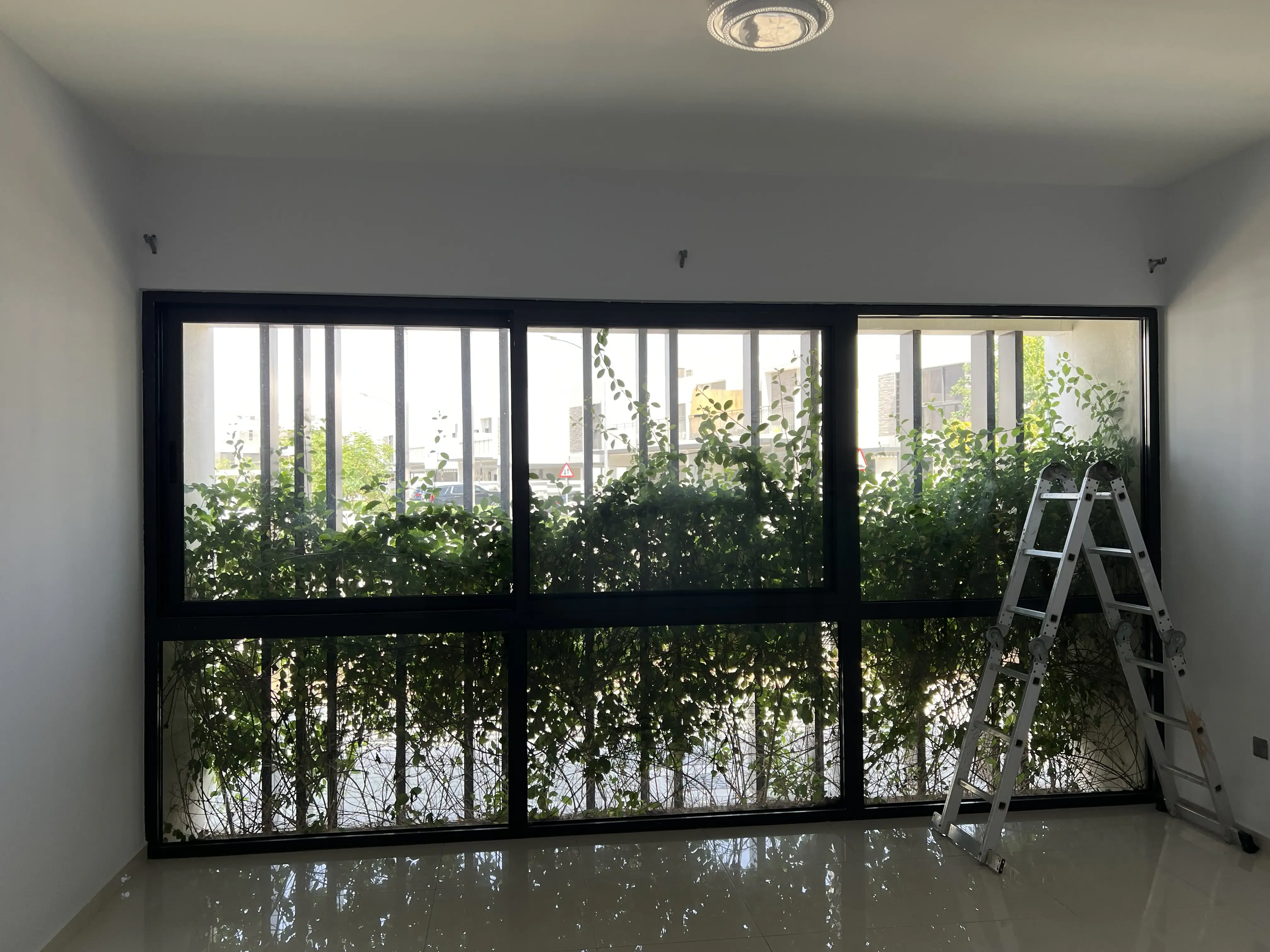 Living room in Dubai showcasing layered drapes, a practical example of curtain colors for gray walls