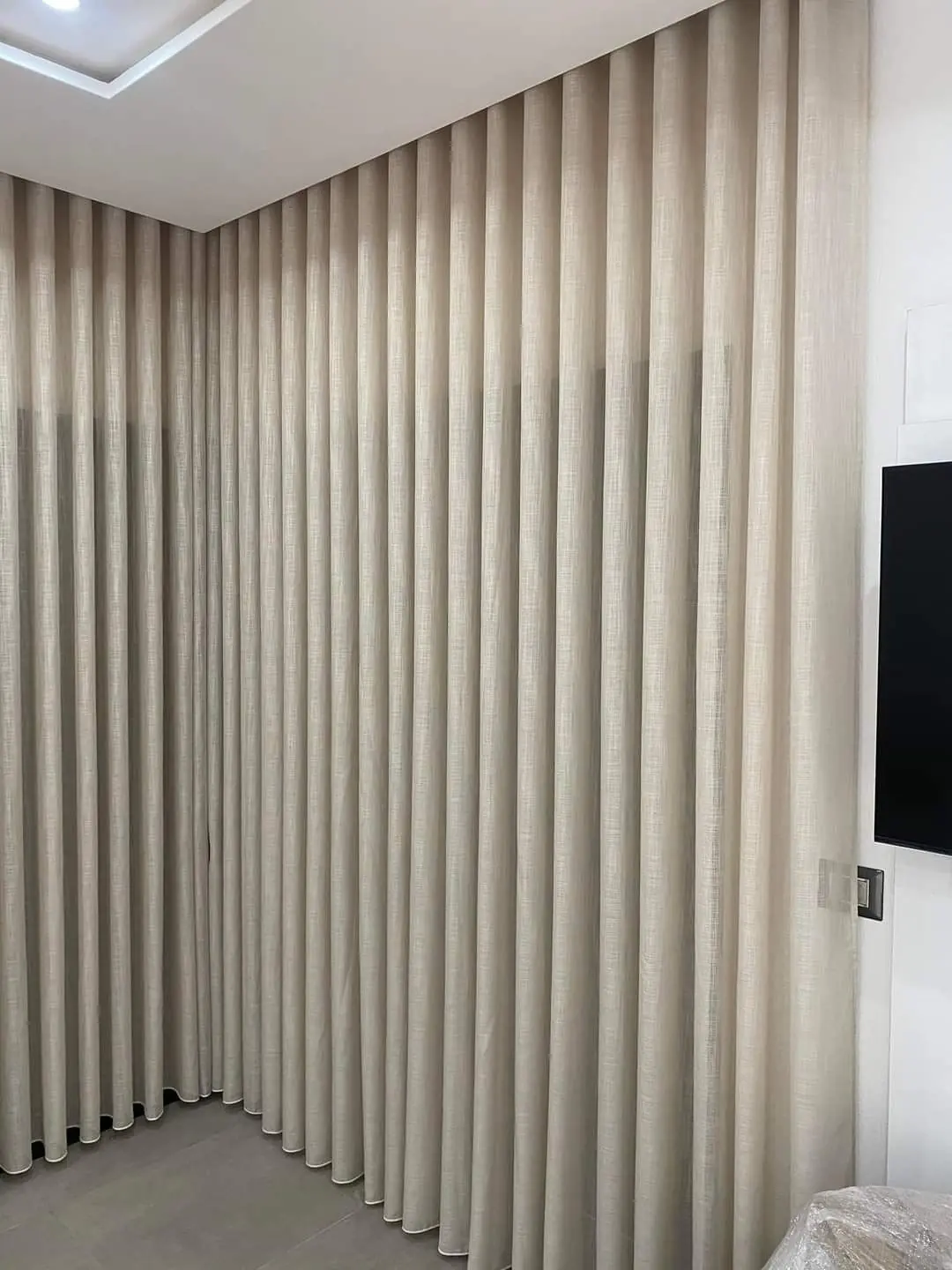 Sheer Curtains UAE Online softly filtering daylight in a Dubai living room Handling Tall Ceilings and Corner Glass
